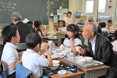 子どもたちと給食をいただく野田敦敬学長