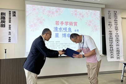 清水咲良氏の代わりに学会長から表彰状を受け取る星博幸教授